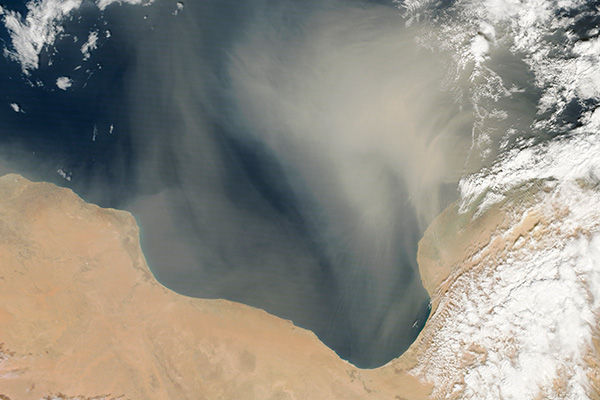 Tormenta de arena sobre aguas libias en 2013. Foto: Jeff Schmaltz / NASA