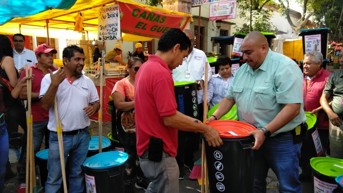 They give away cleaning equipment and trash cans to traders at Guadalupanas Festivals