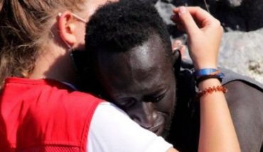 translated from Spanish: The embrace of a migrant with a lifeguard in Ceuta