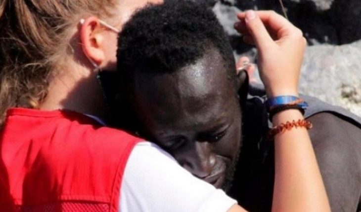 translated from Spanish: The embrace of a migrant with a lifeguard in Ceuta