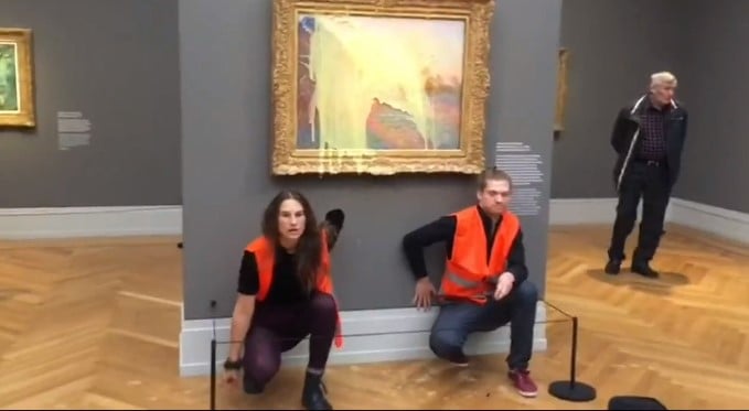 Activists throw mashed potatoes at a Monet painting